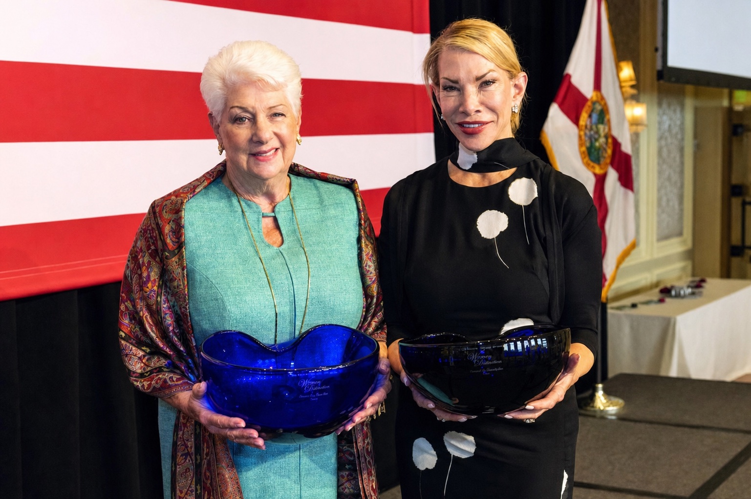Amanda Schumacher and a Women of Distinction honoree holding awards